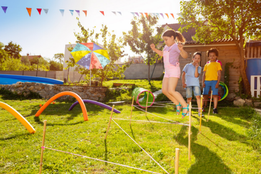 Children playing in the garden with obstacle games. 