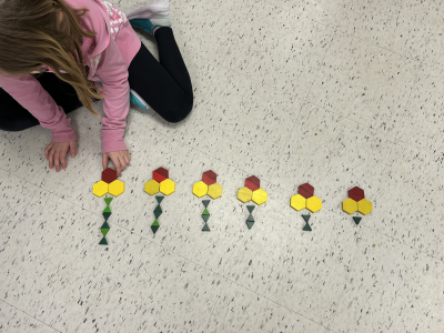 A student making a sequence of flowers with geotic forms.