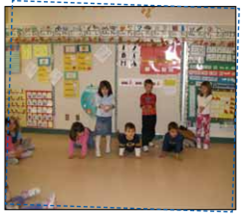 6 children create a sequence with their bodies. The pattern is kneeling, standing, repeated 2 times.