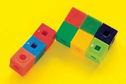 Two figures made of interlocking cubes. The two figures touch each other by an edge.